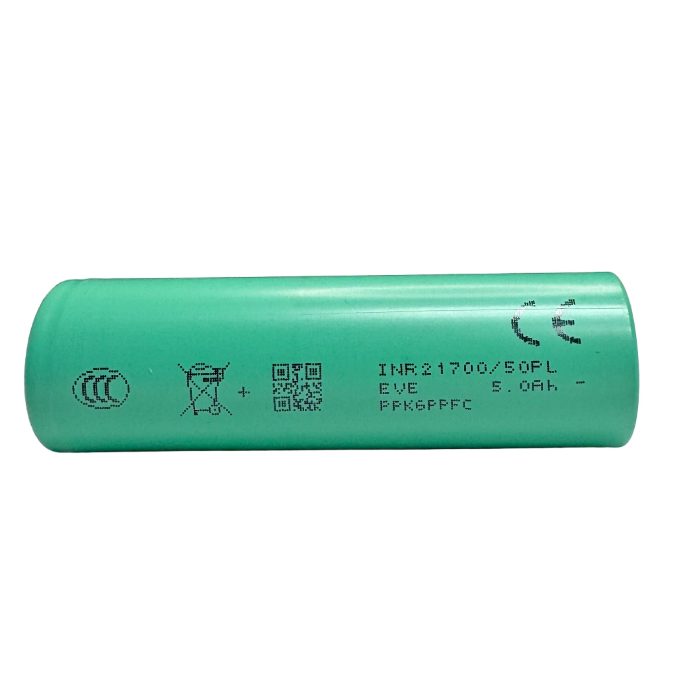 Green cylindrical battery on a light surface with a dark background